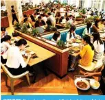  ??  ?? SHENZHEN: Huawei employees eat their lunch in a cafeteria at the company’s headquarte­rs in Shenzhen in China’s southern Guangdong province yesterday.—AFP