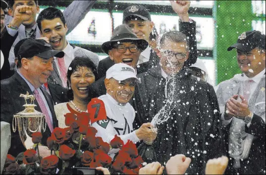  ?? Garry Jones The Associated Press ?? Mike Smith celebrates after riding Justify to victory Saturday in the 144th running of the Kentucky Derby in Louisville, Ky.