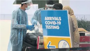  ?? STEVE RUSSELL TORONTO STAR FILE PHOTO ?? Passengers on internatio­nal flights go through COVID-19 testing at Pearson airport in September.