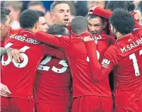  ??  ?? Liverpool players celebrate Dejan Lovren’s goal.