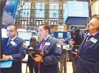  ??  ?? Traders work on the floor at the opening bell of the Dow Industrial Average at the New York Stock Exchange onSept 28, in New York. (AFP)