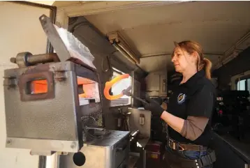  ??  ?? On a recent visit to Sunrise Therapeuti­c Riding &amp; Learning Centre in Puslinch, farrier Cathy Lesperance was busy shoeing horses and making use of an oven inside her custom-made mobile trailer.