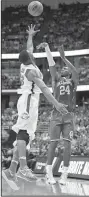  ?? AP/MARK J. TERRILL ?? Oklahoma guard Buddy Hield (right) shoots over Oregon forward Elgin Cook during the second half of Saturday’s game. Hield hit eight three-pointers and scored a game-high 37 points in the Sooners’ victory.