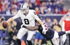  ?? ERIC GAY/ASSOCIATED PRESS ?? Oakland quarterbac­k Connor Cook (8) is sacked by Houston’s Whitney Mercilus during Saturday’s playoff game.