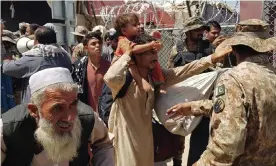  ?? Photograph: AFP/Getty Images ?? Pakistani soldiers check stranded Afghan nationals at a Pakistan-Afghanista­n border crossing in August.