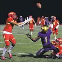  ?? DENIS POROY ?? Cathedral Catholic’s Marcus Ratcliffe (left)intercepts a pass intended for St. Augustine’s Ayo Shotomide during the second half.