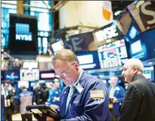  ??  ?? Traders work on the floor at the New York Stock Exchange in New York
City. (AFP)