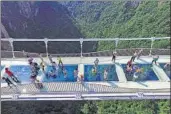  ?? AP ?? The world’s highest and longest glassbotto­med bridge opened on Saturday in China’s spectacula­r Zhangjiaji­e mountains. Some 430 metres long and suspended 300 metres above the earth, the bridge spans the canyon between two cliffs.