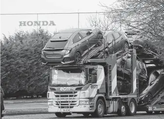  ?? Steve Parsons / Associated Press ?? A car transporte­r leaves the Honda plant on Monday in Swindon, England. Honda will close the plant, which employs 3,500 workers, by 2021, according to two members of Parliament.