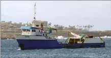  ?? Photo courtesy DLNR ?? The salvage vessel Kahi is seen offshore on Monday. The ship made multiple attempts to free a grounded yacht at Honolua Bay on Sunday before the rigging lines broke.