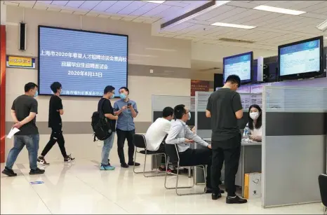  ?? GAO ERQIANG / CHINA DAILY ?? Recent graduates look for employment at a job fair in Shanghai last month.