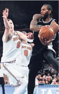  ?? AP ?? San Antonio Spurs forward Kawhi Leonard (right) passes the ball against New York Knicks forward Kristaps Porzingis (left) during the fourth quarter of an NBA game on Tuesday in New York. The Spurs won 100-91.