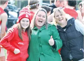  ??  ?? Left: Trafalgar supporters had lots to cheer about in the fourths match on Saturday when the Bloods smashed their opponents. Showing their support at the huddle are Zoe and Lisa Robinson and Cindy Cassar.