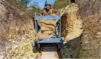  ??  ?? On track: Mr Robertshaw using the light railway designed to carry supplies