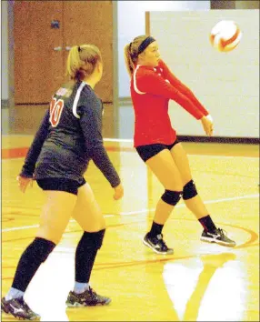  ?? MARK HUMPHREY ENTERPRISE-LEADER ?? Farmington’s Brandy Wallace gets a dig while teammate Callie Phelan stands by ready to help. The Lady Cardinals were defeated 3-0 by 6A power Greenwood Thursday.