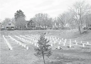  ?? PHOTOS BY HARRISON HILL/ USA TODAY ?? “Say Their Names” cemetery, a memorial to Black people killed by police, was created near George Floyd Square in Minneapoli­s. Names on the tombstones include Breonna Taylor and Tamir Rice.