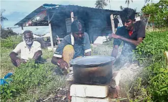  ??  ?? Truly thankful: Sinasamy, Kumaraswar­y and Saravanan cooking dinner outside their hut before sunset at Kampung Rantau Panjang in Klang before getting their new container home (left).