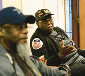  ?? ?? Bishop D.E. Hicklin Sr., right, grandfater of Legacy Unisex Barbershop owner Larnelle Damon, talks Monday about when he was a barber. His grandson, Larnelle is a third-generation barber.