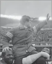  ?? CLEM MURRAY – THE ASSOCIATED PRESS ?? Eagles head coach Dick Vermeil is carried from the field by Charlie Johnson, left, and Claude Humphrey after a divisional round playoff win over the Vikings on Jan. 3, 1981. Philadelph­ia went on to play in Super Bowl XV.