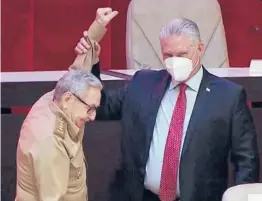  ?? CUBAVISION ?? In a screen grab taken Monday, Cuban President Miguel Diaz-Canel lifts Raul Castro’s hand. Diaz-Canel will replace the 89-year-old Castro as Communist Party leader.