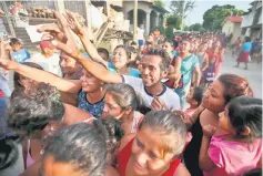  ??  ?? People queue to receive food donations. — Reuters photo