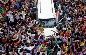  ?? — ABHIJIT MUKHERJEE ?? BJP president Amit Shah waves at supporters as he leaves after lunch at a party worker’s house in Kashipur, Kolkata, on Wednesday.