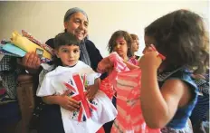  ?? Reuters ?? Sana Ebrahim Al Taee, who is in poor health with vocal cord paralysis, with her grandchild­ren at her home in Mosul.