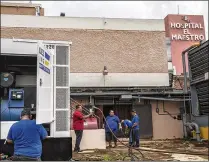  ?? VICTOR J. BLUE / NEW YORK TIMES ?? Workers set up a second generator Tuesday at Hospital El Maestro in San Juan, Puerto Rico. People are dying because of the lack of medicine and electricit­y for ventilator­s, dialysis equipment and other survival tools, writes Carla Minet.