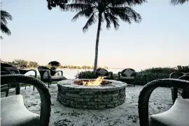  ?? ALEXIA FODERE Miami Herald file ?? In this 2008 photo, a waterfront view and fire pit beckon at Baleen, the once popular restaurant at Grove Isle.