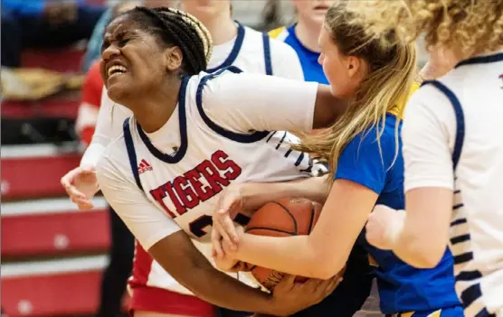  ?? Pittsburgh Post-Gazette ?? McKeesport’s Kaylee Charles fights for a loose ball against Hampton on Friday in the fourth quarter during a WPIAL Class 5A quarterfin­al at Fox Chapel High School. McKeesport won the game, 55-44.