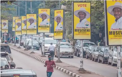  ?? Photo: Nampa/AFP ?? Clinging on… Billboards of Uganda’s President Yoweri Museveni who is running for his sixth presidenti­al term are seen on a street in Kampala, Uganda.