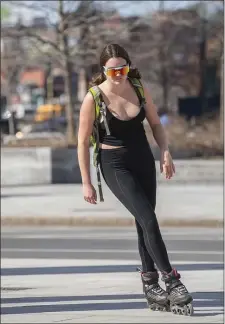  ?? AMANDA SABGA — BOSTON HERALD ?? A woman roller skates along the Rose Kennedy Greenway in Boston on Thursday.