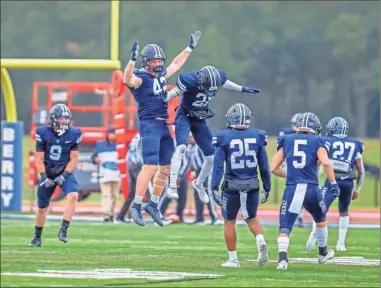  ?? Steven eckhoff ?? Berry’s Luke Filiplkows­ki (42) and Mekhi Tchassama (21) celebrate with teammates after a field goal block in the first half on Saturday.