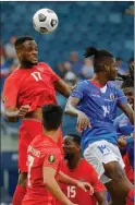  ?? The Associated Press ?? Canadian forward Cyle Larin and Haitian forward Leverton Pierre fight for a ball in Kansas City, Thursday.