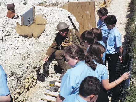  ?? — PHOTOS: KEITH MORGAN ?? British students get a taste of what life was like in First World War trenches during visit to the Dingle farm trench display in the English county of Kent.