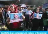  ??  ?? BAGHDAD: Iraqi protesters hold pictures of the premierdes­ignate Mohammad Allawi with the inscriptio­n “rejected” during an anti-government demonstrat­ion in the capital’s Tahrir Square yesterday. — AFP