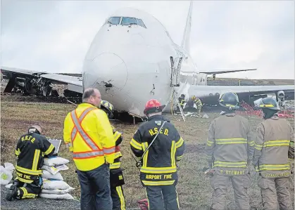  ?? ANDREW VAUGHAN THE CANADIAN PRESS ?? A SkyLease Cargo plane skidded off Runway 14 just after 5 a.m. It wasn’t clear what caused the accident that left two engines sheared off.
