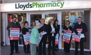  ??  ?? Staff on strike at Lloyds Pharmacy at Castle Street Shopping Centre in Bray.