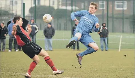  ??  ?? High- kicking action from the big Peterborou­gh League match won2- 0 by Moulton Harrox against Netherton last weekend. Moulton’s Andy Law is the man with the studs showing to the concern of Netherton’s Ben Daly.