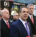  ?? MARK LENNIHAN—THE ASSOCIATED PRESS ?? New York Gov. Andrew Cuomo speaks to members of the media after a pipe bomb strapped to a man went off in a New York City subway near Times Square on Monday, Dec. 11in New York. Mayor Bill de Blasio stands fourth from left. Cuomo’s recent comments,...