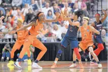  ?? JESSICA HILL/ASSOCIATED PRESS ?? Washington’s Kristi Toliver, center, is swarmed by Connecticu­t’s Jonquel Jones, left, and Natisha Hiedeman during Game 4 of the WNBA Finals Tuesday.