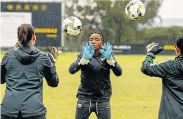  ?? Picture: MICHAEL SHEEHAN/GALLO IMAGES ?? BRAVING THE RAIN: Banyana Banyana goalkeeper Andile Dlamini trains with teammates at Nelson Mandela University’s 2nd Avenue campus on Thursday