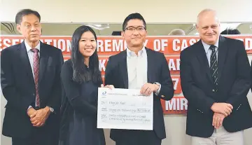  ??  ?? Jie Yun (second left) receives the mock cheque for her Daiken Scholarshi­p from Michiro, as Wong and Mienczakow­ski (right) look on.