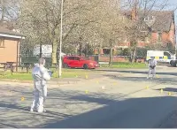 ??  ?? ●●Police forensic officers at the scene of the stabbing