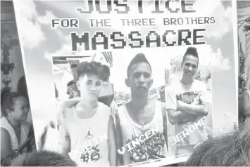  ??  ?? A huge tarpaulin calling for justice is put up at the wake of the three Umpad brothers outside the Cebu Internatio­nal Convention Center in Mandaue City.