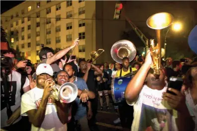  ?? Associated Press ?? Da Truth Brass Band plays Wednesday as the statue of Confederat­e general P.G.T. Beauregard is being prepared for removal from the entrance to City Park in New Orleans. The statue came down just after 3 a.m. Wednesday. The city council voted to remove...