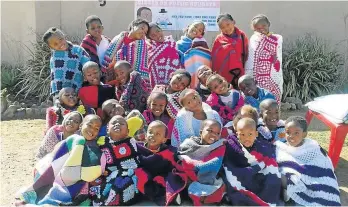  ?? Picture: SUPPLIED ?? JOYFUL SMILES: Pupils of Masiqhame Educare in Mdantsane receive blankets from the 67 Blankets initiative