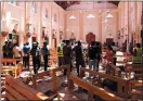  ?? GETTY IMAGES ?? Security personnel walk through debris after an explosion in St. Sebastian’s Church in Negombo, north of Colombo, on Sunday.