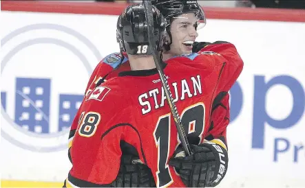  ?? COLLEEN DE NEVE/ CALGARY HERALD ?? Flames' forwards Sean Monahan and Matt Stajan celebrate after defeating the Los Angeles Kings on Thursday at the Scotiabank Saddledome. Calgary clinched a playoff berth with the 3- 1 win over the reigning Stanley Cup champions.