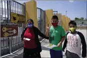  ?? DAMIAN DOVARGANES — THE ASSOCIATED PRESS ?? Parent Maria Hernandez, with her sons, Edwin Gomez, 10, and Jesus Gomez, 9, arrive to get tested at a COVID-19 testing and vaccinatio­n site at the Roybal Learning Center in Los Angeles on Thursday.